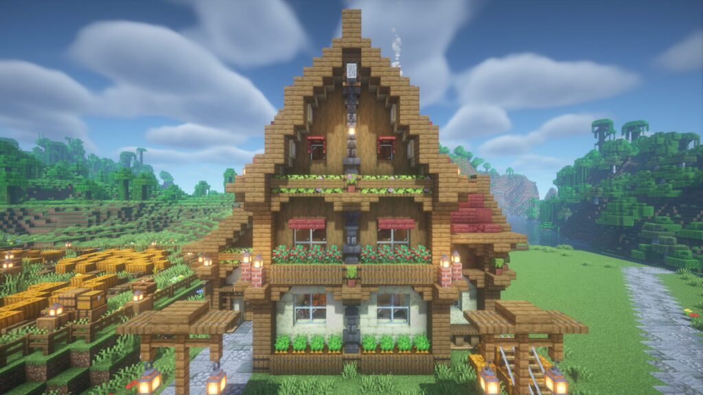 マインクラフトで建築した赤い屋根のカフェの正面外観。クリーム色と木材の壁の対比や、中央の金床を使った特徴的な柱の装飾が見える。