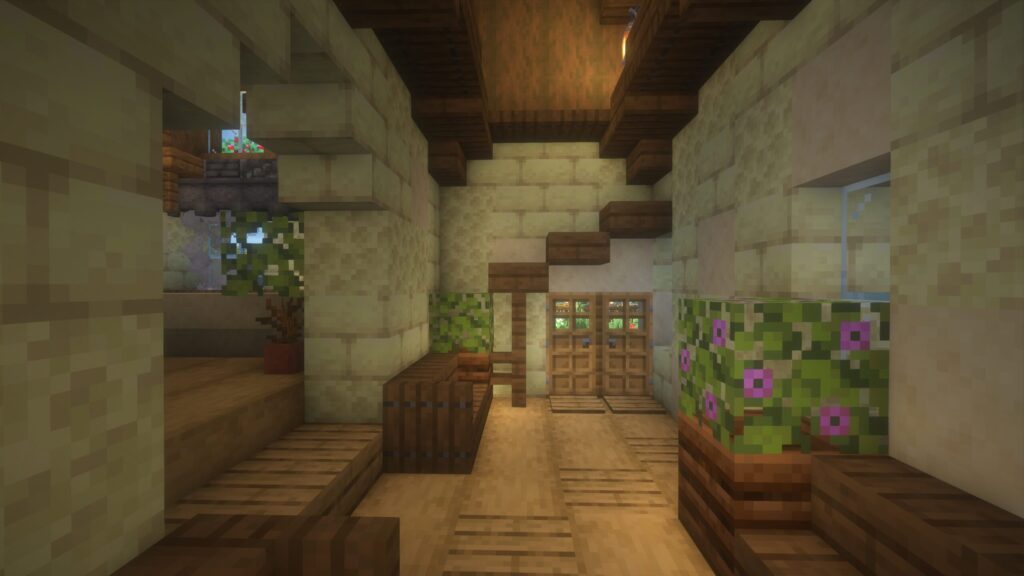 待合室からカフェ本体へと続く段差の様子。増築した設定を感じさせる構造と、木の温もりに包まれた空間。