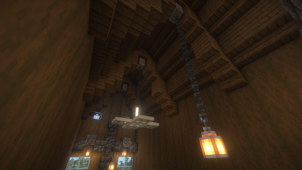 マインクラフトで建築したカフェの高い天井。鎖で吊るされたランタンと、鉄のトラップドアで作られたシーリングファンが見える開放的な内装。